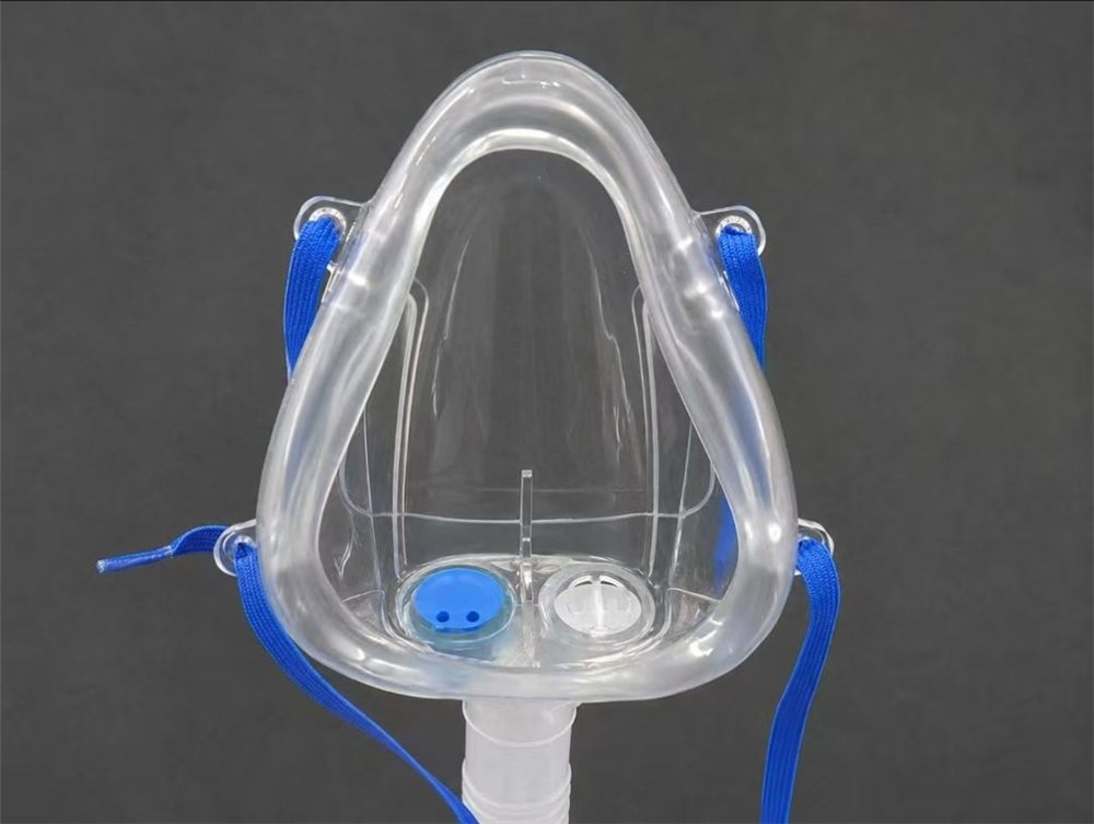 BIBS system: transparent oxygen mask with its blue head straps and dedicated breathing circuit